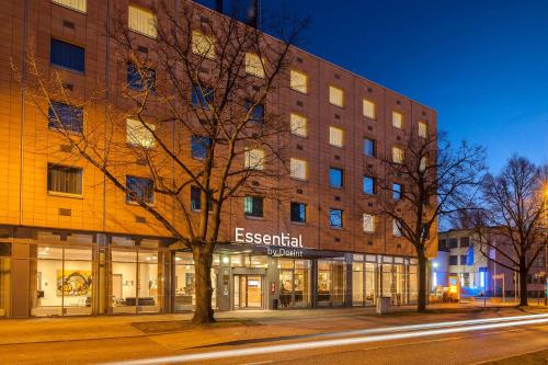 a building on a street in front of a building at Essential by Dorint Berlin-Adlershof in Berlin