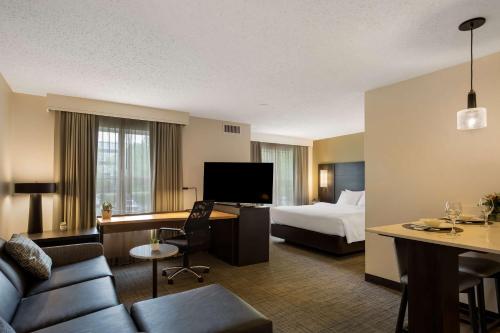 a hotel room with a bed and a living room at Sonesta ES Suites Parsippany Morris Plains in Parsippany