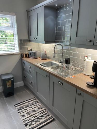 a kitchen with a sink and a counter top at St Elmos Townhouse in Derry Londonderry