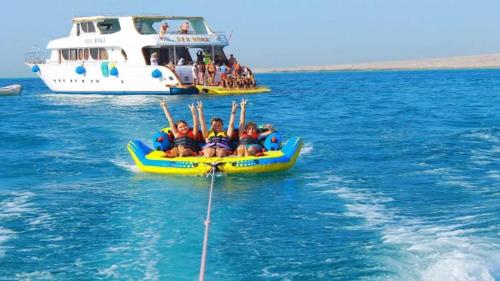 a group of people riding on a raft in the water at Four Seasons Hotel in Hurghada