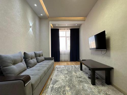 a living room with a couch and a table at Dushanbe City View Apartments in Dushanbe