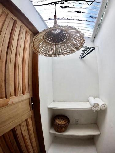 a bathroom with a toilet under a ceiling at Sitio Namaste in Itacaré