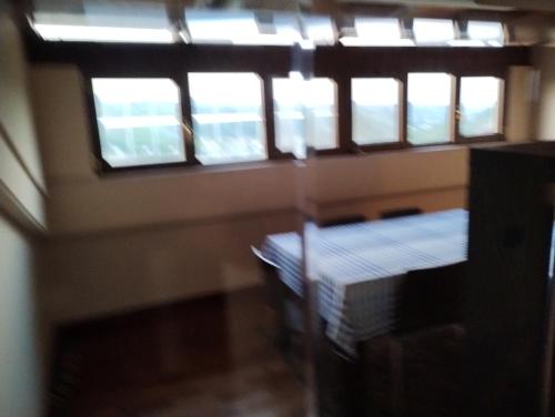 a room with three windows and a bed in it at Rocky House in Ripa Teatina