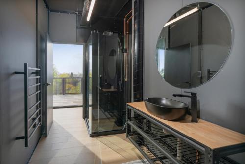 a bathroom with a sink and a large mirror at Panorama Vista in Pauanui