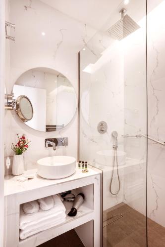 a white bathroom with a sink and a shower at DAYS City Suites Athens in Athens