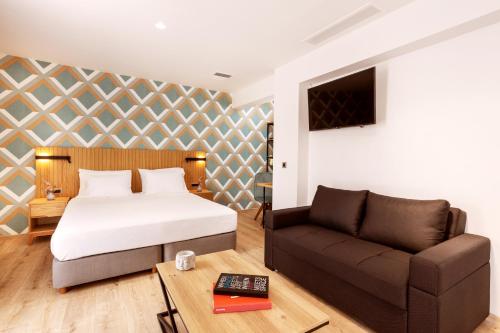 a bedroom with a bed and a couch at DAYS City Suites Athens in Athens