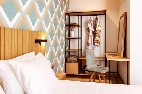 a bedroom with a bed and a desk and a chair at DAYS City Suites Athens in Athens