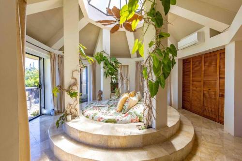 a bedroom with a circular bed in the middle of a room at Waterfall House with Ocean Views in Haiku, Maui in Huelo
