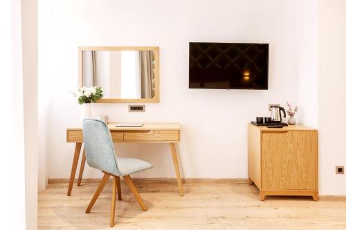 a desk with a chair and a mirror at DAYS City Suites Athens in Athens
