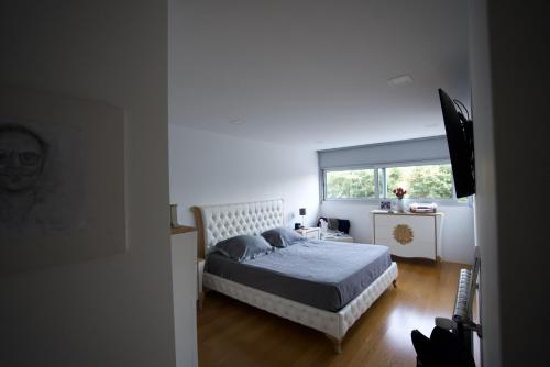 a bedroom with a bed and a window at Esposende Resort - Golf, Beach, River, Tennis, Pool in Gemezes