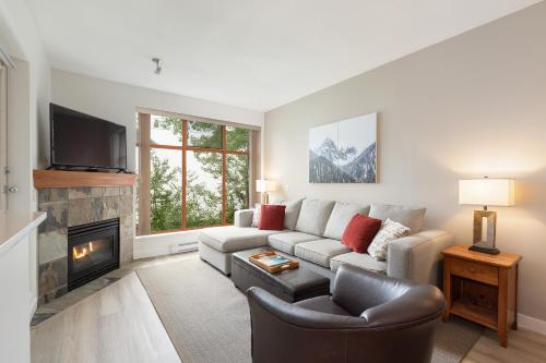 a living room with a couch and a fireplace at Northstar at Stoney Creek by Whiski Jack in Whistler