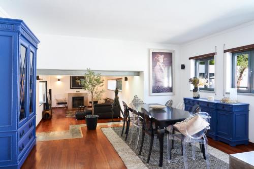 a living room with blue cabinets and a table at Casa do Moinho in Abrantes