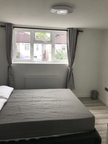 a bed in a room with a large window at 30A Mortlake in London