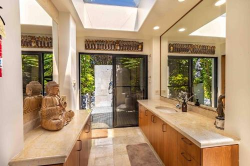 a bathroom with a statue sitting on a counter at Cliff House with Ocean Views in Haiku, Maui jungle in Huelo