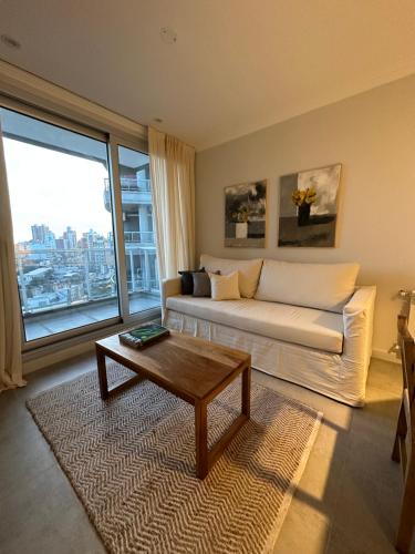 a living room with a couch and a coffee table at Departamento en Santa Fe Capital, sobre calle Boulevard Pellegrini in Santa Fe