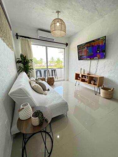 a white room with a bed and a table in it at Departamento nuevo a estrenar! in Manzanillo