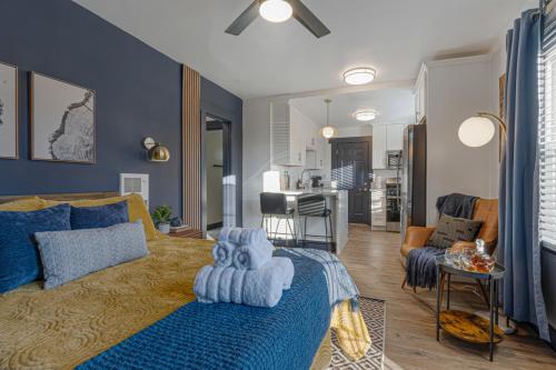 a bedroom with a bed and a living room at Chic Oasis Studio: Minutes to Downtown & Beaches in National City