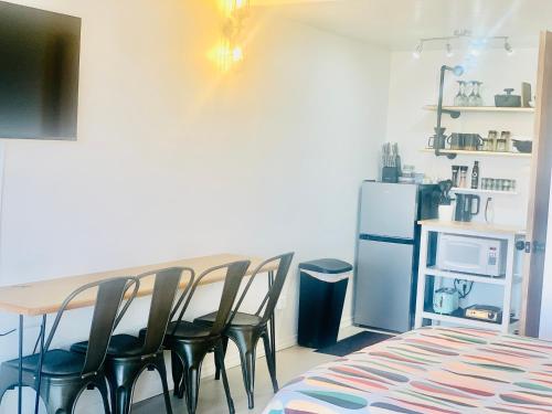 a kitchen with a table and chairs and a refrigerator at Dragonfly Motor Lodge in Panguitch