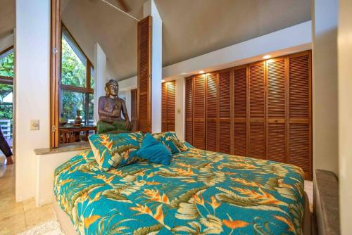 a bedroom with a large bed with a large window at Jasmine Suite on Lush farm in Haiku, Maui jungle in Huelo