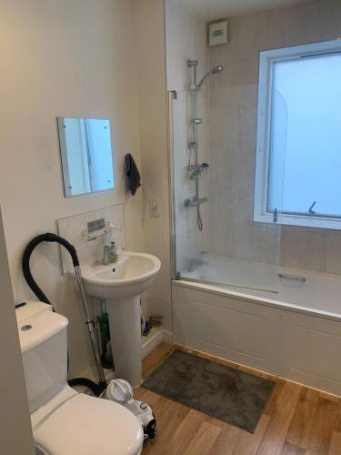 a bathroom with a toilet and a sink and a shower at 2SWEETZ HOME 2 in Erith