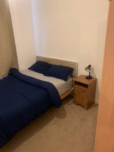 a small bedroom with a bed and a night stand at 2SWEETZ HOME 2 in Erith