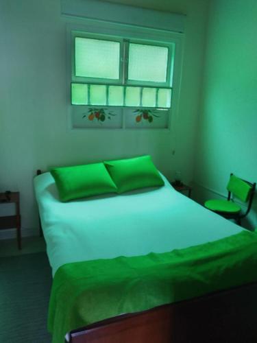a bedroom with a white bed with a window at Finca La Tobita Eco Hotel in Toca