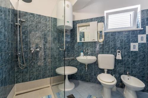 a bathroom with two toilets and a shower and a sink at Apartments with a parking space Tar, Porec - 6948 in Tar