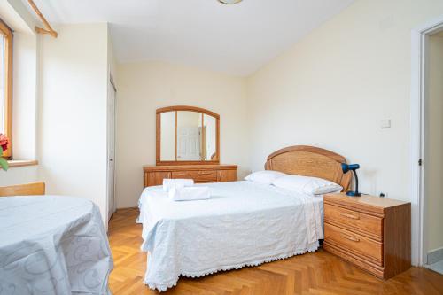 a bedroom with two beds and a mirror at Triple Room Mrljane 327a in Neviđane