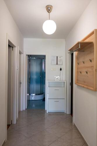 a hallway with a sink and a shower in a room at Apartments by the sea Postira, Brac - 14822 in Postira