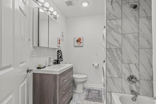 a bathroom with a sink and a toilet and a shower at Stay Rafa At 259 in Philadelphia