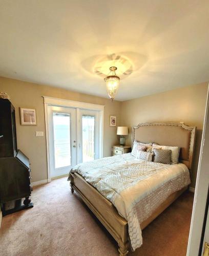 a bedroom with a large bed and a television at Vista Del Mare Vacation Properties in Cavendish