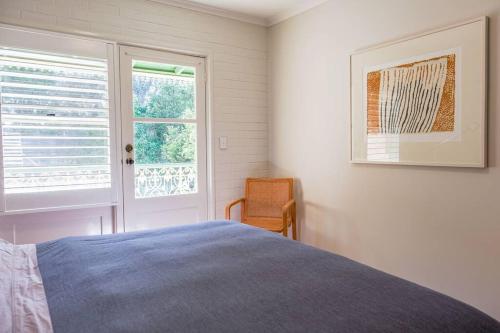 a white bedroom with a bed and a window at Modern Boutique CBD 2BR 1st Floor Apt in Canberra