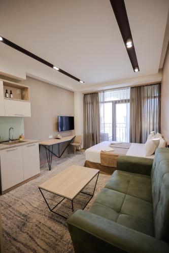 a hotel room with a bed and a couch at Rooftop Apart-Hotel in Yerevan