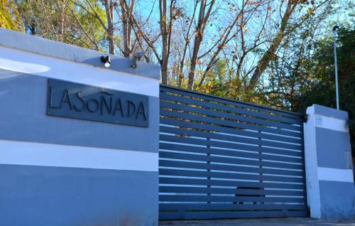 a white garage door with a sign on it at La Soñada in Chilecito