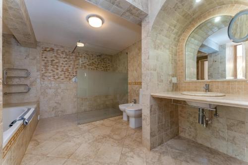 a bathroom with a sink and a toilet and a tub at The Quinta Bio Pool, Swimming Pool, 3 Bedroom ensuites Villa in Almancil