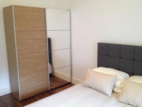 a bedroom with a bed and a mirror at Caledonian Apartments in Edinburgh
