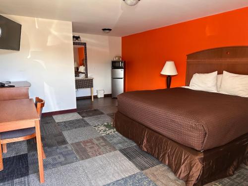 a hotel room with a bed and a desk at Gateway Lodge in Rifle