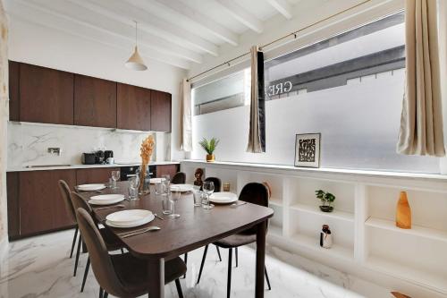 a kitchen and dining room with a table and chairs at Very nice triplex apartment bright in Montorgueil in Paris