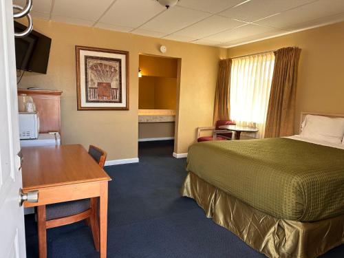 a hotel room with a bed and a desk at Gateway Lodge in Rifle