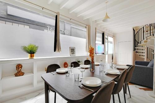 a dining room with a table and chairs at Very nice triplex apartment bright in Montorgueil in Paris
