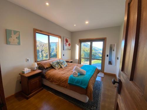 a bedroom with a bed and a large window at Wild Weka Eco Stay - Off-Grid 4WD RECOMMENDED in Waimarie