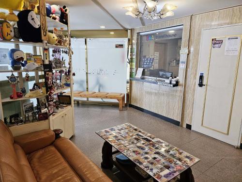 a living room with a couch and a table at BoA Travel House in Seoul