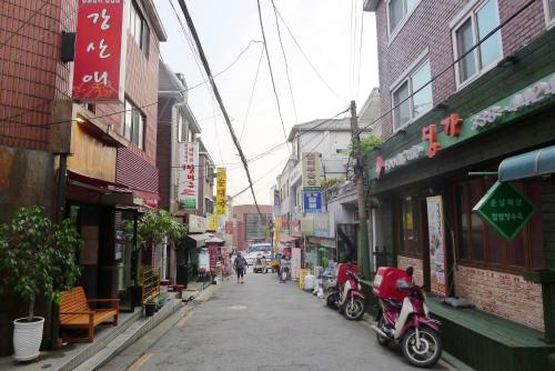 a city street with motorcycles parked on the side at BoA Travel House in Seoul