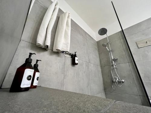 une salle de bain avec une douche avec deux bouteilles sur un comptoir dans l'établissement Selbard Suite, à Buenos Aires