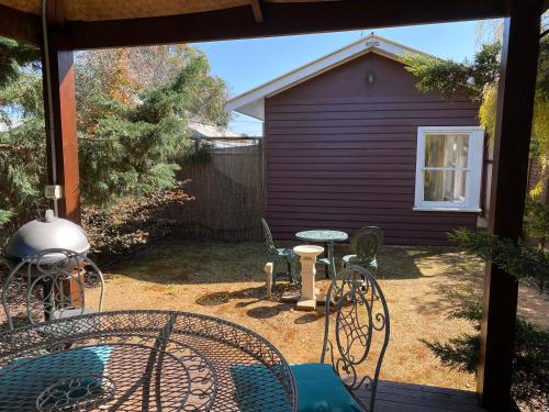 a patio with chairs and a table and a house at R&R Blue Diamond Luxury Studio Maryborough, Vic in Maryborough