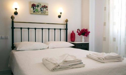 a bedroom with a bed with white towels on it at Panorama Hotel in Naxos Chora