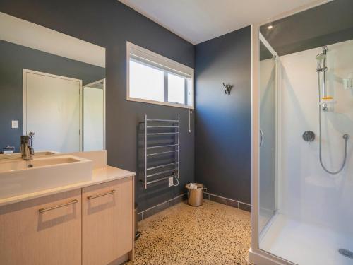 a bathroom with a sink and a shower at Aquila Waters - Whitianga Holiday Home in Whitianga