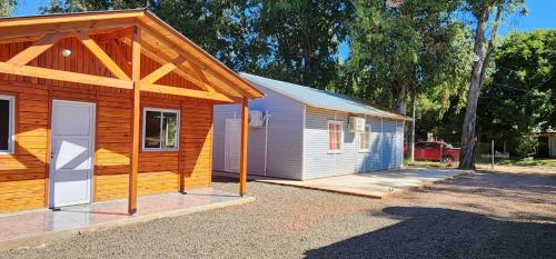 una pequeña casa con un garaje al lado en Cabaña Itu en Ituzaingó