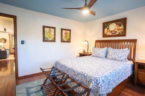 a bedroom with a bed and a ceiling fan at Tropical & Serene Ground Floor in Kihei