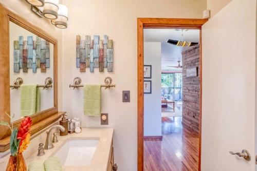 a bathroom with a sink and a mirror at Tropical & Serene Ground Floor in Kihei